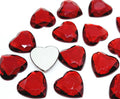 Pile of 20mm faceted dark red resin heart gem cabochons (cabs), one flipped to show the flat back