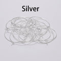 Pile of silver round wire earring hoops under a Silver label