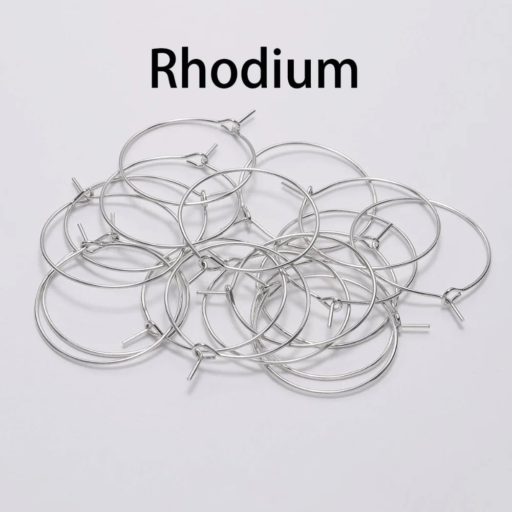 Pile of rhodium round wire earring hoops under a Rhodium label