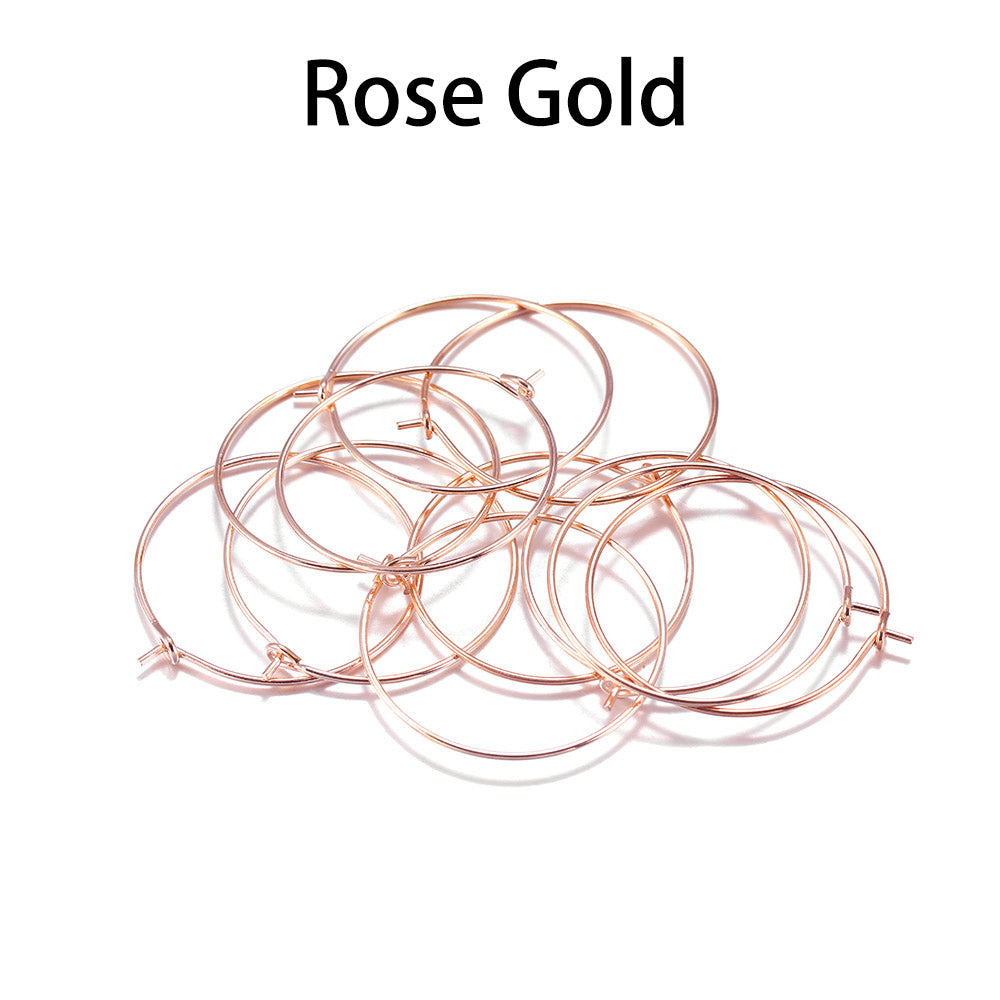 Pile of rose gold round wire earring hoops under a Rose Gold label