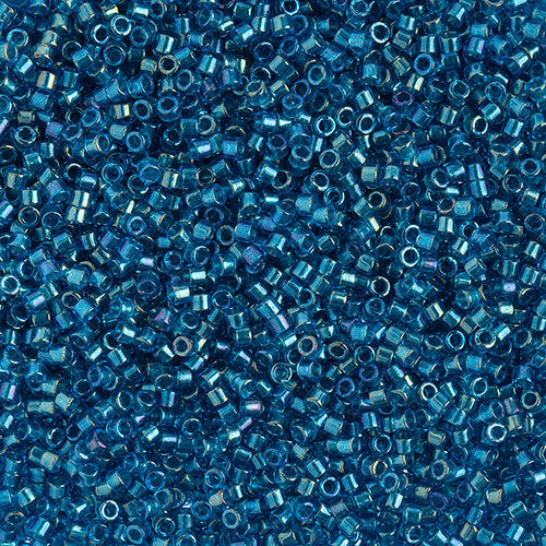 Close-up of Miyuki Delica 11/0 DB2385 cylinder beads in teal blue with an AB rainbow finish