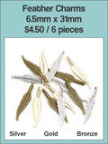 Pile of 6.5 x 31mm feather charms in silver, gold and bronze tone