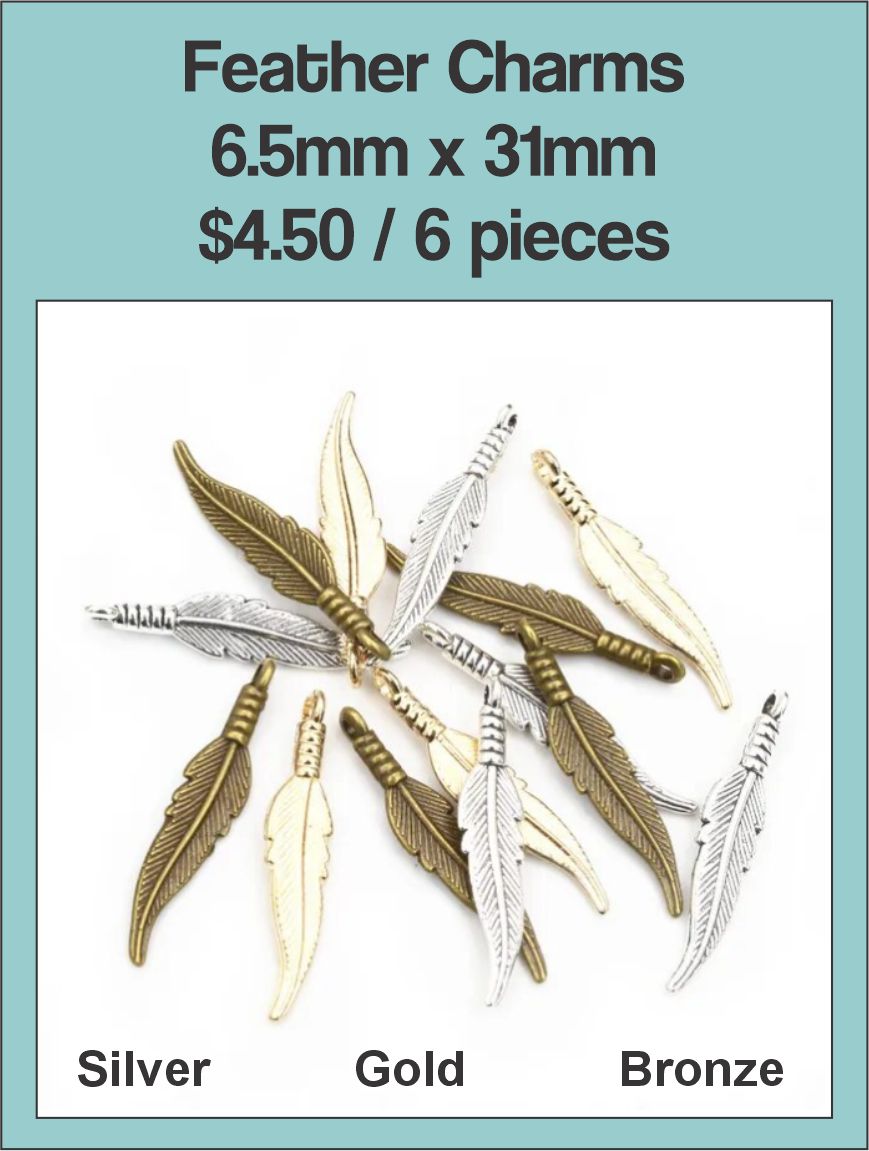 Pile of 6.5 x 31mm feather charms in silver, gold and bronze tone