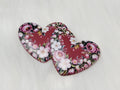 Pair of 37mm resin heart cabochons (cabs) in burgundy with a frame of pink roses and white blossoms