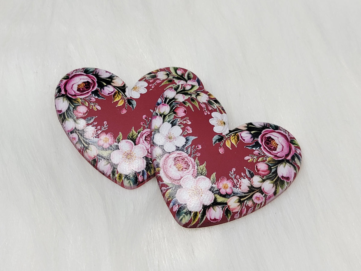 Pair of 37mm resin heart cabochons (cabs) in burgundy with a frame of pink roses and white blossoms