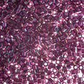 Close-up of Miyuki Delica 11/0 DB1747 cylinder beads in fuchsia lined amethyst with an AB rainbow finish