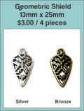 13 x 25mm geometric shield charms with a cut-out pattern in silver and bronze