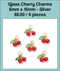 Six 6 x 15mm red glass cherry charms with green leaves and silver-tone stems