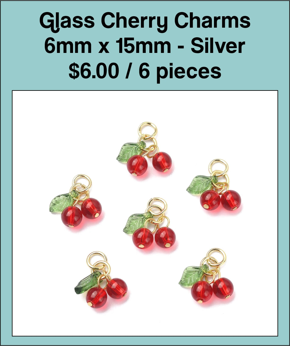 Six 6 x 15mm red glass cherry charms with green leaves and silver-tone stems