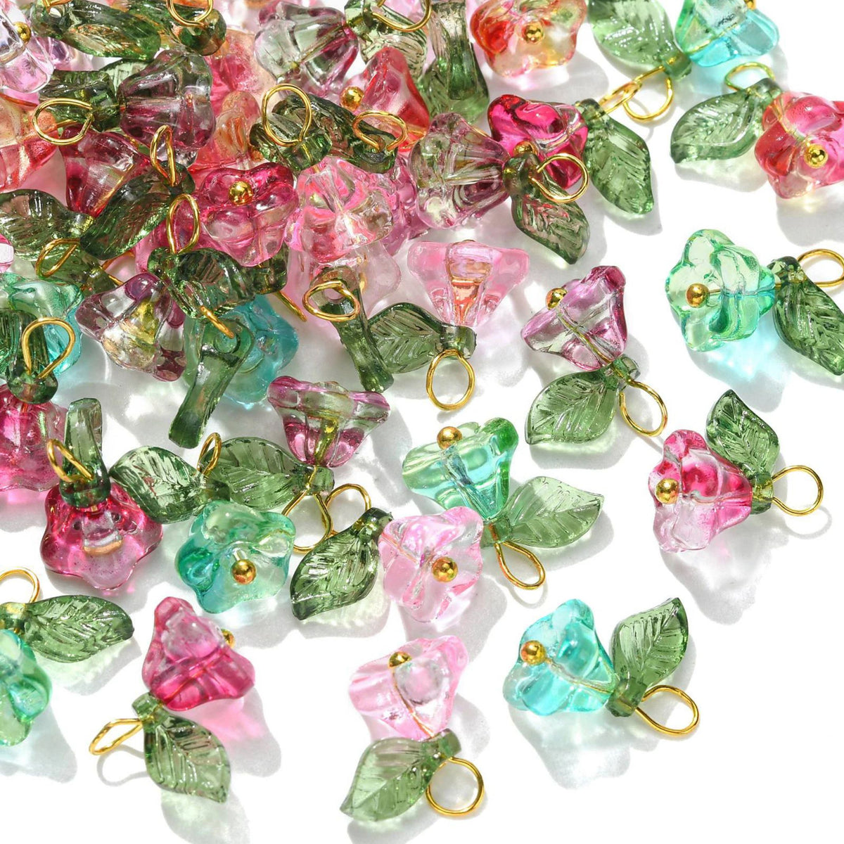Pile of 8 x 14mm glass flower charms in pink, red and green with green glass leaves