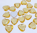 Pile of 20mm faceted gold resin heart gem cabochons (cabs), one flipped to show the flat back