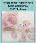 Pile of 16 x 23mm acrylic petal charms in pink with gold-tone edges