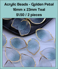 Pile of 16 x 23mm acrylic petal charms in teal with gold-tone edges
