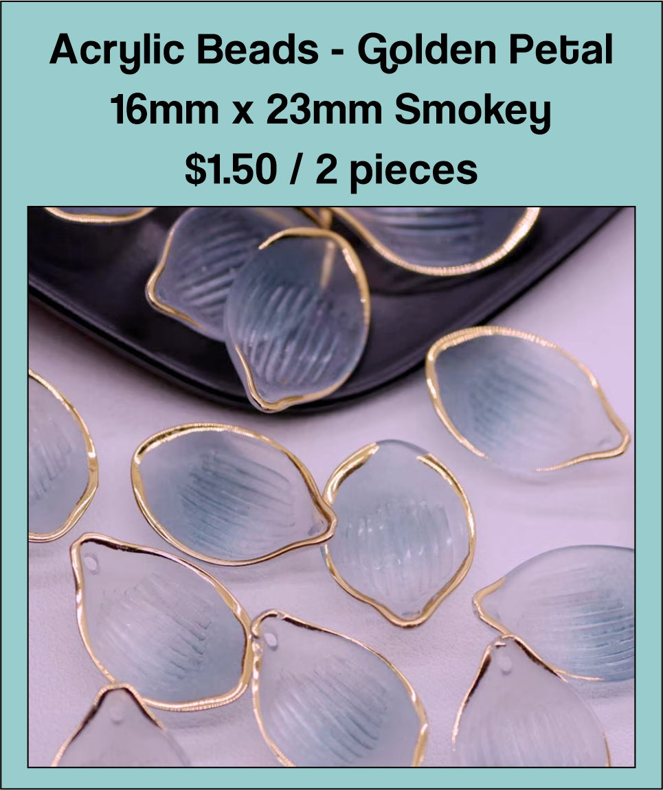 Pile of 16 x 23mm acrylic petal charms in smoky blue-grey with gold-tone edges
