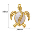 Gold-tone 30 x 24mm turtle pendant with a white shell inlay and size markings