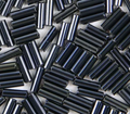 Close-up of loose 6mm Preciosa Czech glass bugle beads in gunmetal