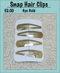 Card of four gold snap hair clips under a Snap Hair Clips heading