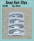 Card of four silver snap hair clips under a Snap Hair Clips heading