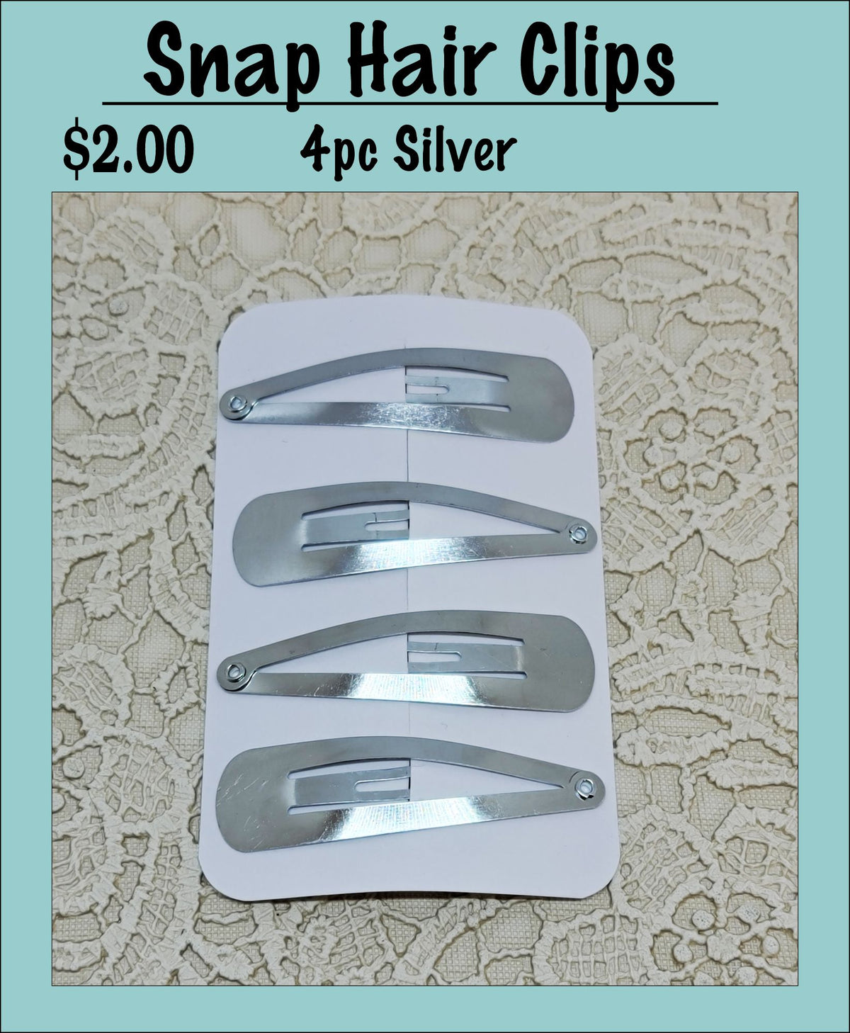 Card of four silver snap hair clips under a Snap Hair Clips heading