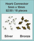 Tiny 5 x 10mm heart connectors in silver and bronze tone on a labelled product card