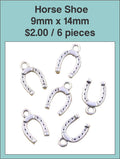 Six silver-tone 9 x 14mm horseshoe charms on a labelled product card