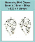 Two silver-tone 21 x 35mm hummingbird charms with a flower on a labelled product card