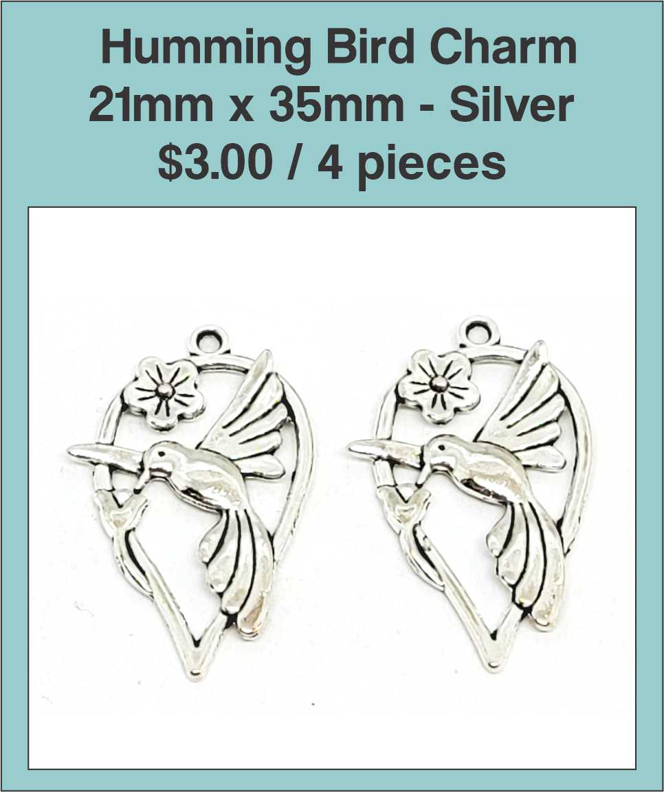 Two silver-tone 21 x 35mm hummingbird charms with a flower on a labelled product card
