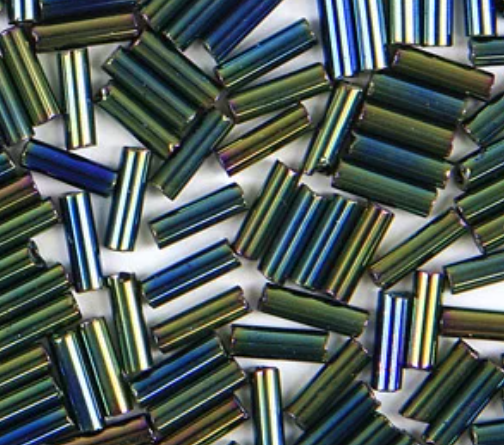 Close-up of loose 6mm Preciosa Czech glass bugle beads in iris green