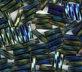 Close-up of loose twisted 6mm Preciosa Czech glass bugle beads in iris green
