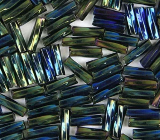 Close-up of loose twisted 6mm Preciosa Czech glass bugle beads in iris green