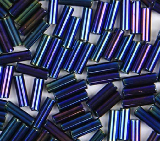 Close-up of loose 6mm Preciosa Czech glass bugle beads in iris navy