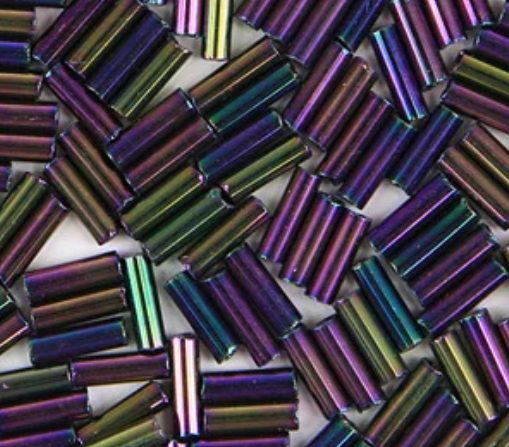 Close-up of loose 6mm Preciosa Czech glass bugle beads in iris purple