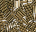 Close-up of loose 6mm Preciosa Czech glass bugle beads in metallic light bronze