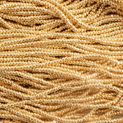 Close-up of strung Preciosa 13/0 true cut charlotte beads in metallic gold