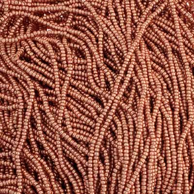 Close-up of strung Preciosa 13/0 true cut charlotte beads in metallic light copper terra