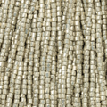 Close-up of strung Preciosa 9/0 three-cut glass seed beads in metallic light silver