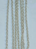 Hanging strands of 2mm silver stainless steel link chain against a white background