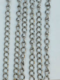 Hanging strands of 3 x 4mm rhodium stainless steel link chain