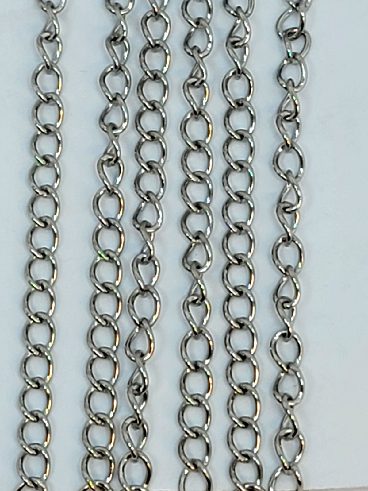 Hanging strands of 3 x 4mm rhodium stainless steel link chain