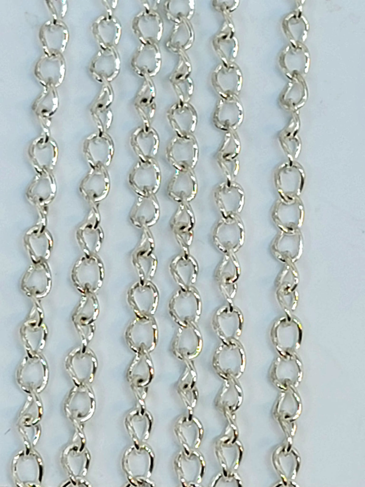 Hanging strands of 3 x 4mm silver stainless steel link chain