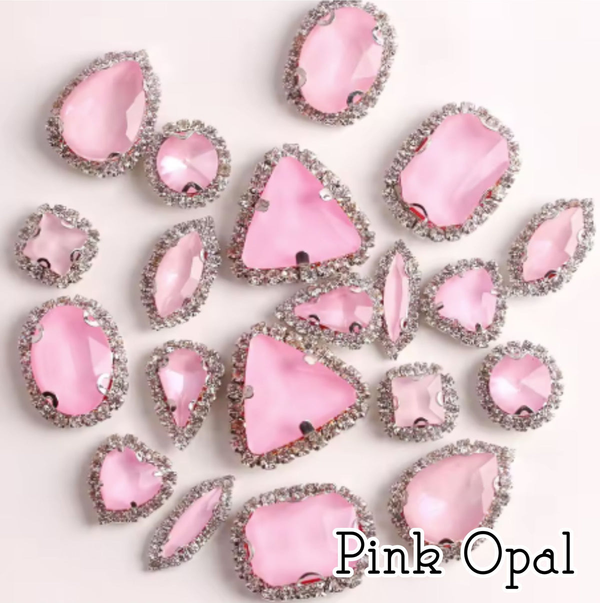 Sew-on crystal rhinestones in pink opal, in 10 shapes with silver claw settings