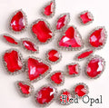 Sew-on crystal rhinestones in red opal, in 10 shapes with silver claw settings