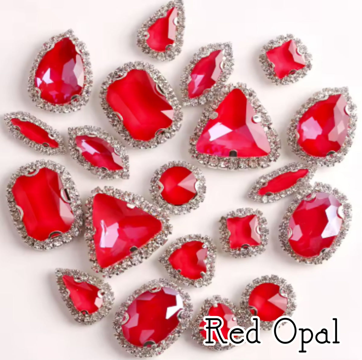Sew-on crystal rhinestones in red opal, in 10 shapes with silver claw settings