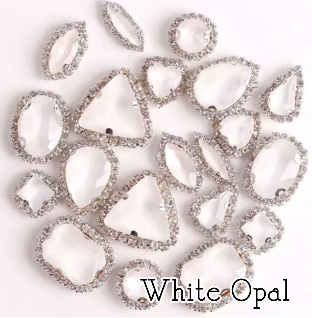 Sew-on crystal rhinestones in white opal, in 10 shapes with silver claw settings