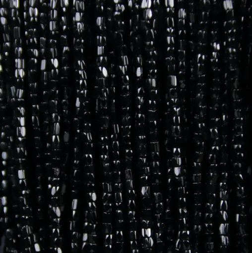 Close-up of strung Preciosa 9/0 three-cut glass seed beads in opaque black