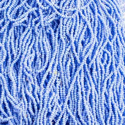 Close-up of strung Preciosa 13/0 true cut charlotte beads in opaque blue with an AB rainbow finish