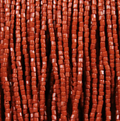 Close-up of strung Preciosa 9/0 three-cut glass seed beads in opaque brown