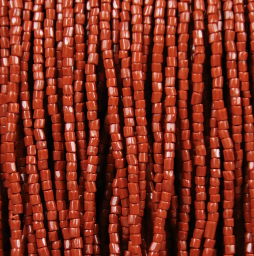 Close-up of strung Preciosa 9/0 three-cut glass seed beads in opaque brown