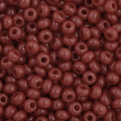 Close-up of Preciosa 11/0 Czech glass seed beads in opaque cranberry