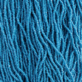 Close-up of strung Preciosa 13/0 true cut charlotte beads in opaque dark blue